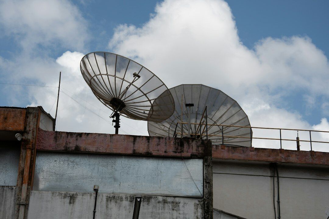 Satellite uplink dish pointed at the sky for live broadcast transmission