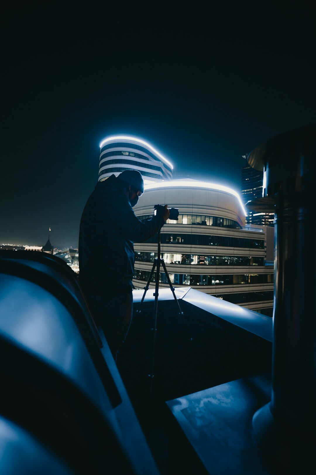 Camera operator setting up a broadcast camera on location outdoors