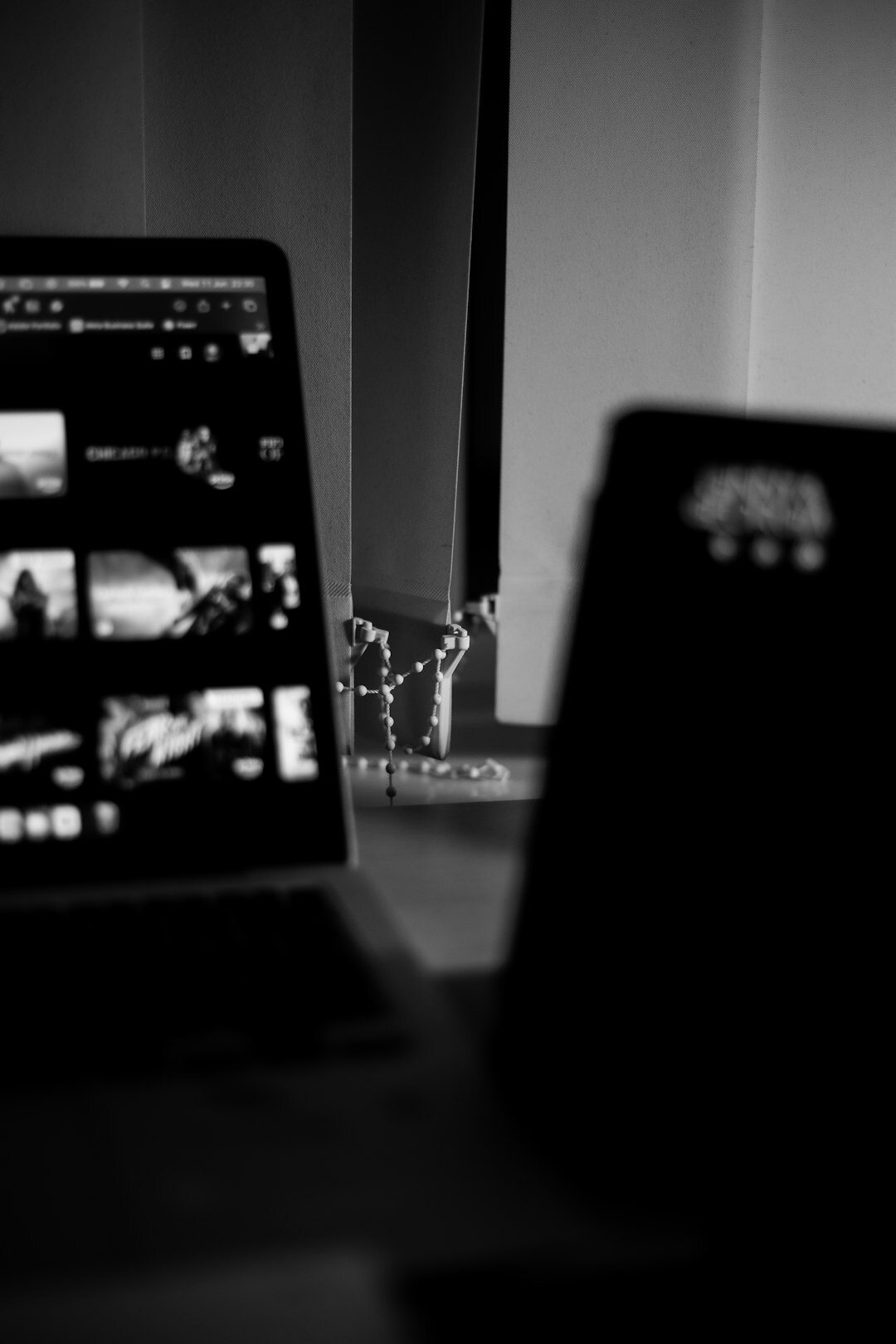 Video editor reviewing footage and waveform data on a laptop and monitor